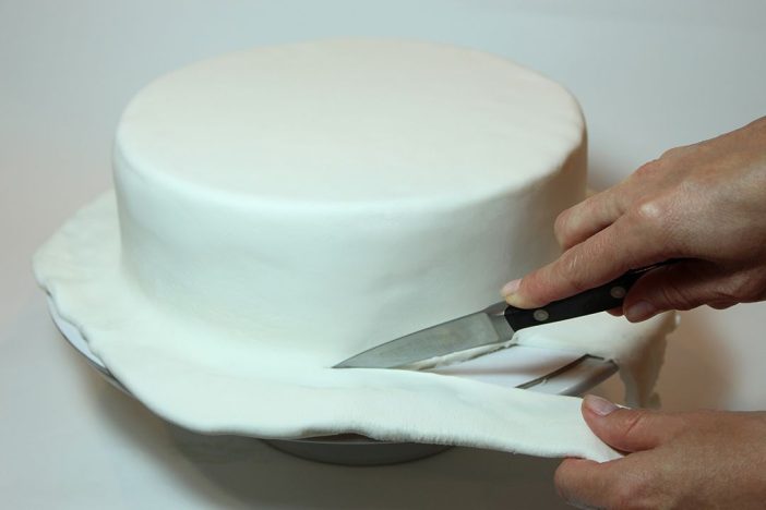covering cake with fondant