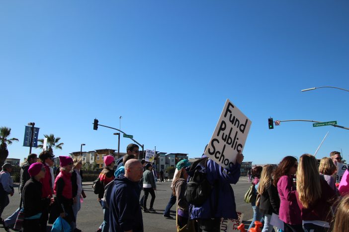 march signs fund public schools